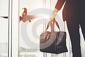 Man Standing in Airport and Looking at Plane