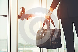 Man Standing in Airport and Looking at Plane