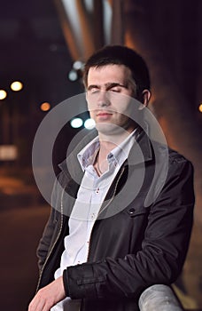 Man is standing alone on night bridge