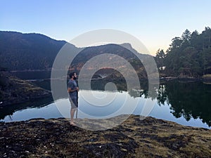 A Man standing along the shores of the Gulf Islands