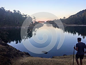 A Man standing along the shores of the Gulf Islands in British Columbia, Canada, thinking and contemplating