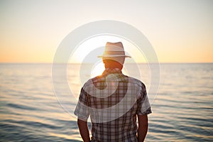 Man standing backlight sunset lighting back view