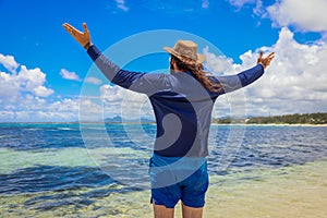 Man Standing on Beach With Arms Wide Open