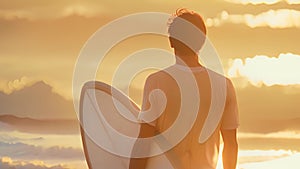 Man standing on beach holding surfboard