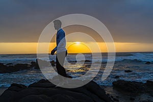 Man Standing Beach Ocean Rocks Silhouetted