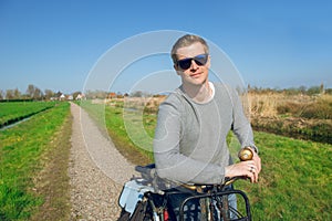 Man standing with a bike