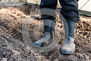 Man standing in boots on soil