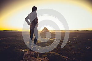 Man standing on cliff above valley