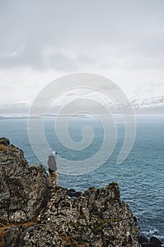 A Man standing on cliff in rainy day, travel lifestyle concept