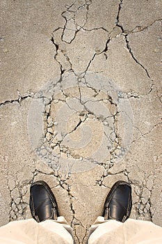 A man standing on crack ground