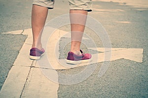 man standing at the crossroad with direction