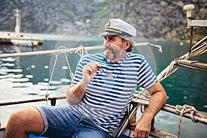 Man standing on the deck of his boat on a sunny afternoon