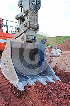 Man standing in a digger bucket