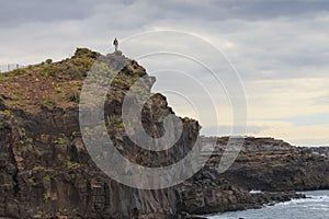 Man standing on the edge of cliff Callo salvaje, Tenerife Canary islands photo