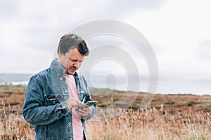 Man is standing on edge of the cliff on Irish sea