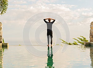 A man standing at the edge of infinity pool