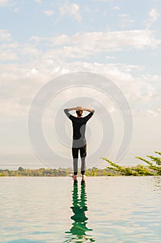 A man standing at the edge of infinity pool