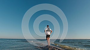 The man is standing on the edge of the Kinburn Spit early morning, Ukraine