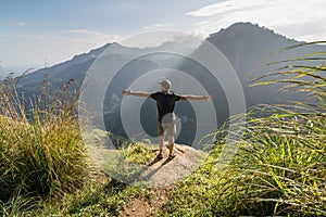 Man Standing at the Edge of Little Adam's Peak photo