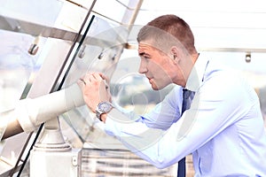 Man standing on the edge and looking at the city