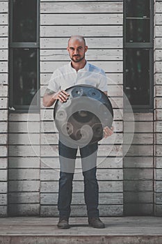 Man is standing eith hangdrum