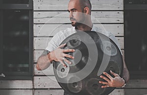 Man is standing eith hangdrum