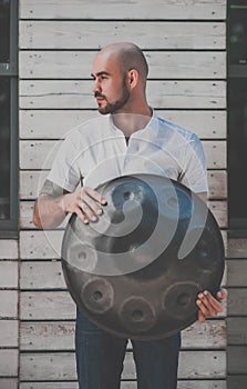 Man is standing eith hangdrum