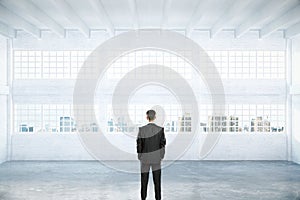 Man standing in empty hangar