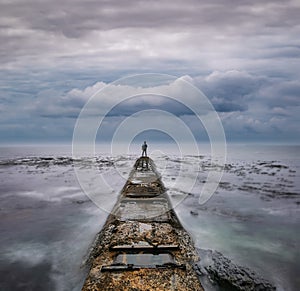 Man standing at the end of the road of life