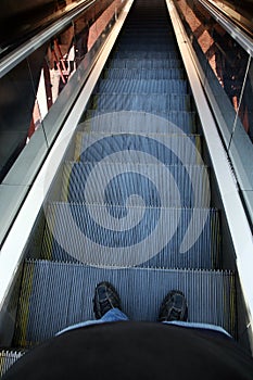 Man standing on an escalator