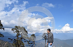 A man standing and feel freedom at Dochula Pass near The 108 memorial chortens or stupas known as Druk Wangyal Chortens at the