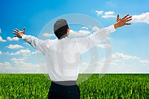 Man standing at the field at sunny day