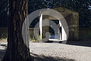 Man standing in flooding sunlight in a stone vault.