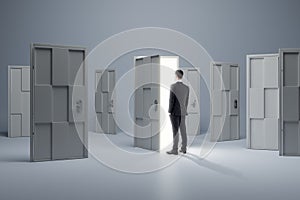 Man standing in front of abstract white puzzle door in interior. Future, choice, success, direction, opportunity and solution
