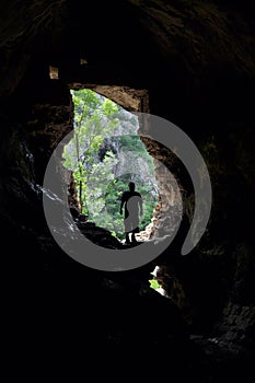 Man standing in front of a cave entrance