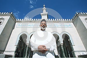 A man standing in front of an Islamic Study Center