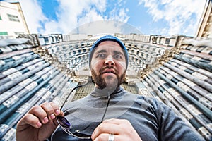 Man standing in front of San Lorenzo cathedral in Genoa, Italy - looking strange