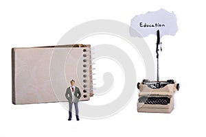 Man typewriter and a spiral notebook