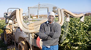 Man standing at fumigator on artichoke plantation