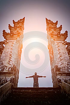 Man is standing in the gate of Lempuyang temple on Bali isalnd