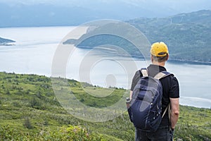 Man Standing and Gazing Out to Bonne Bay Fjord photo