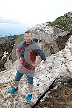 Man standing on glacier on Lago-Naki plateau in summer