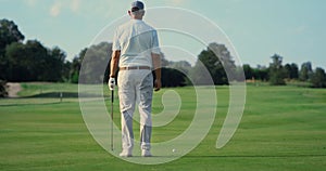 Man standing golf course alone outdoors. Sport player enjoy fresh air in summer.