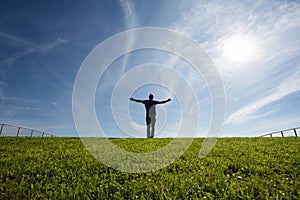 Man standing on grass in sunlight photo