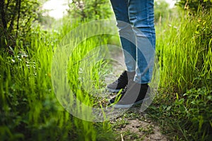 The man is standing in the grass. Vibrant background of lush blades of green grass