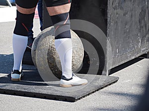 Man Standing at Heavy Concrete Ball