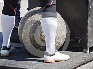 Man Standing at Heavy Concrete Ball