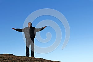 A man standing high up on a mountain