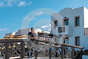 Man standing at the hotel and looking at the seaside