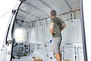 Man standing inside an empty van